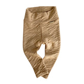 Beige baby pants with a brand logo on a white background