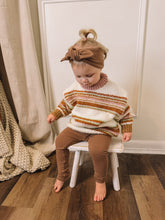 Toddler Girl in Mocha Leggings Sitting on Chair