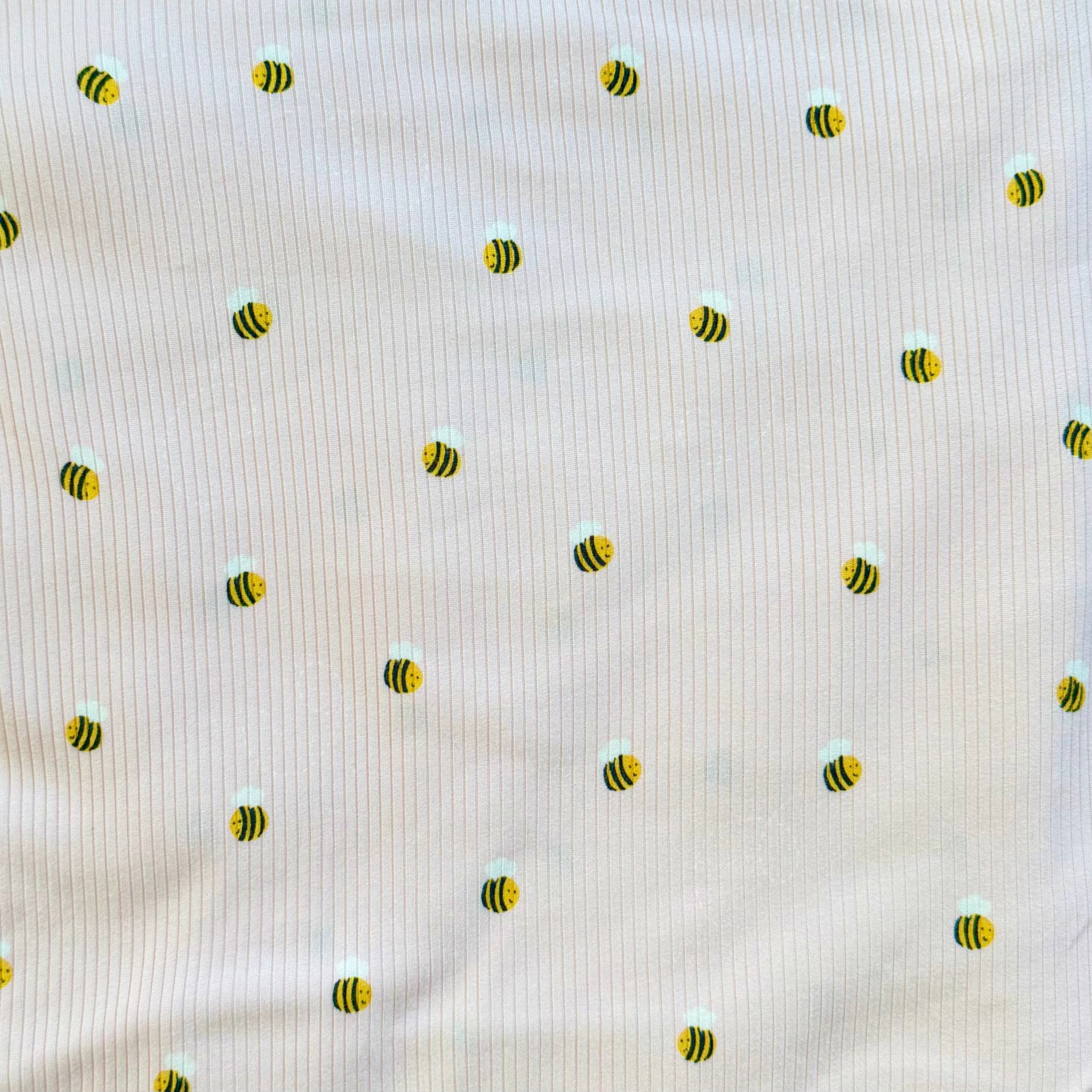 Pattern of small bees on a textured beige background