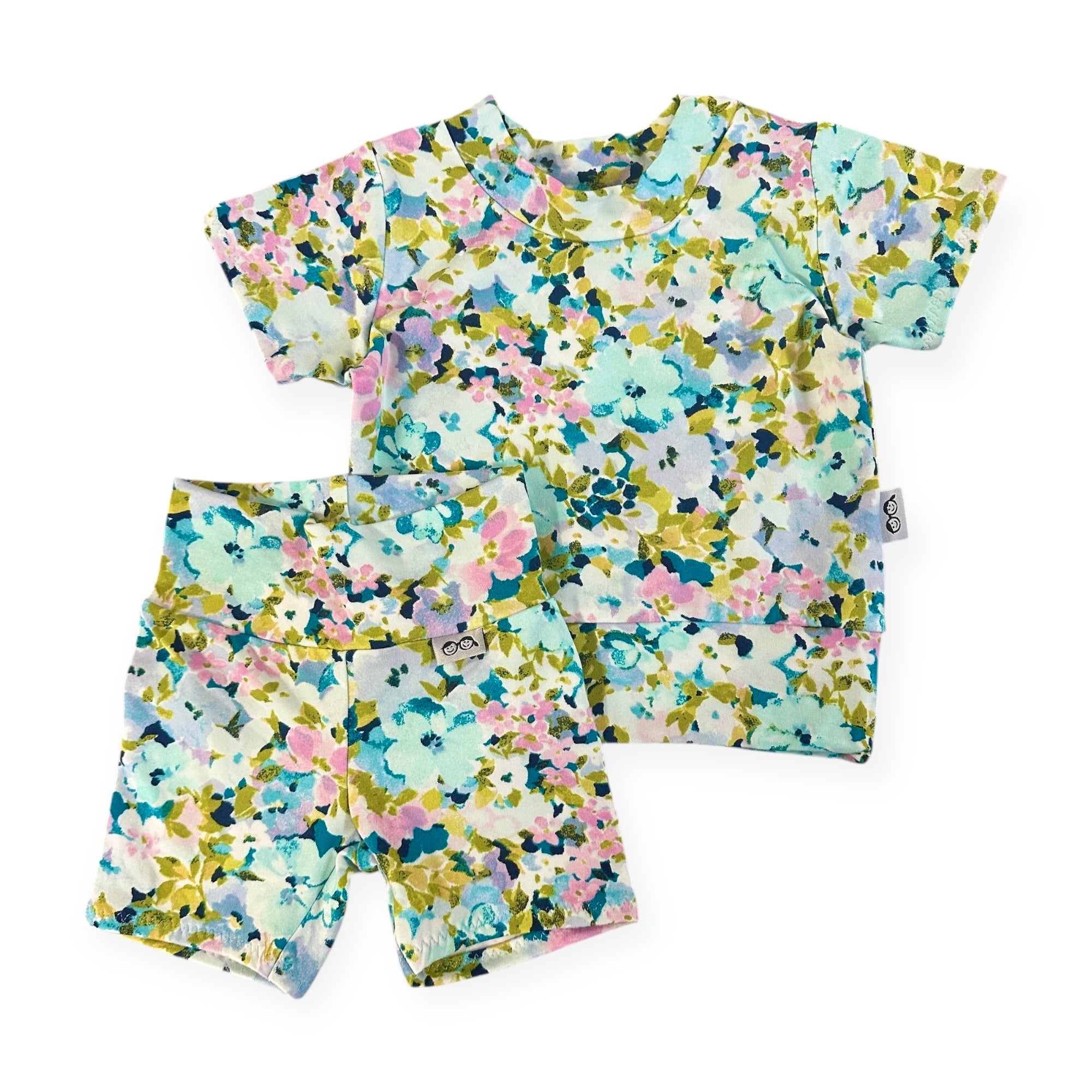 Floral patterned shirt and shorts set on a white background