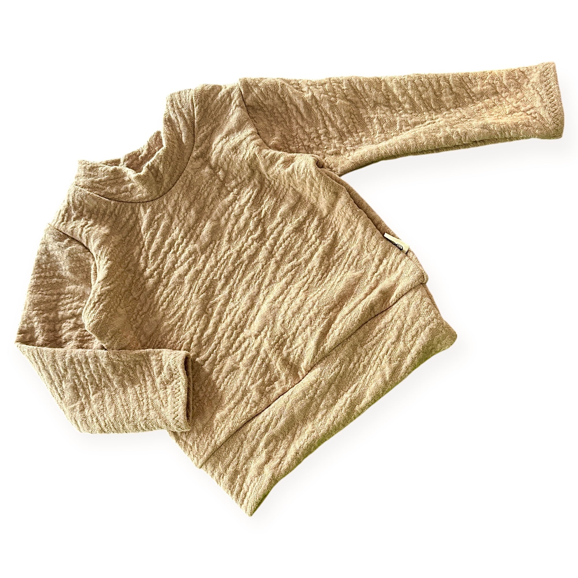 Beige camel textured sweater on a white background