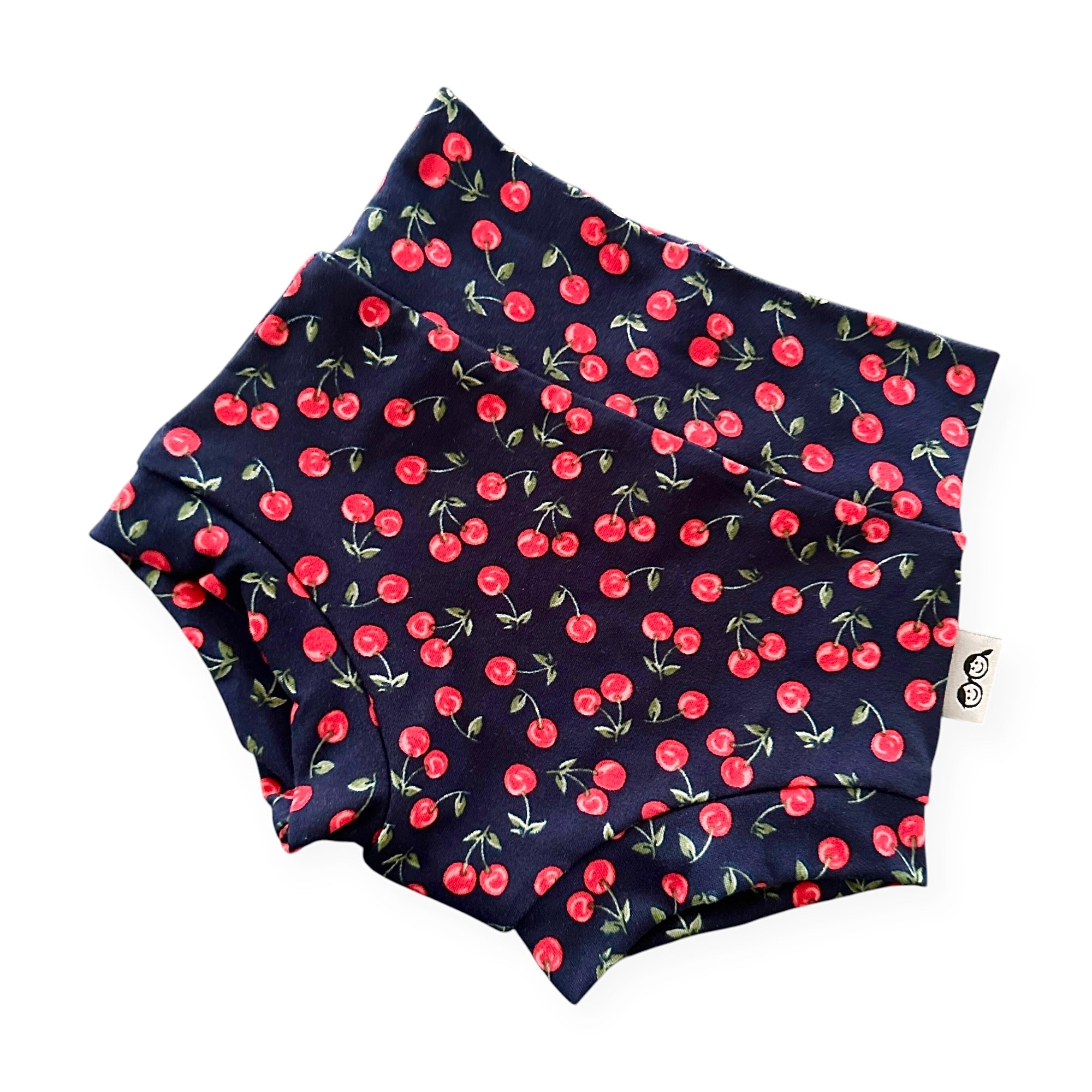 Midnight Cherries high-waisted baby bummies – soft, stretchy diaper cover with an adorable cherry print. Trendy baby girl shorts, perfect for a stylish baby wardrobe.