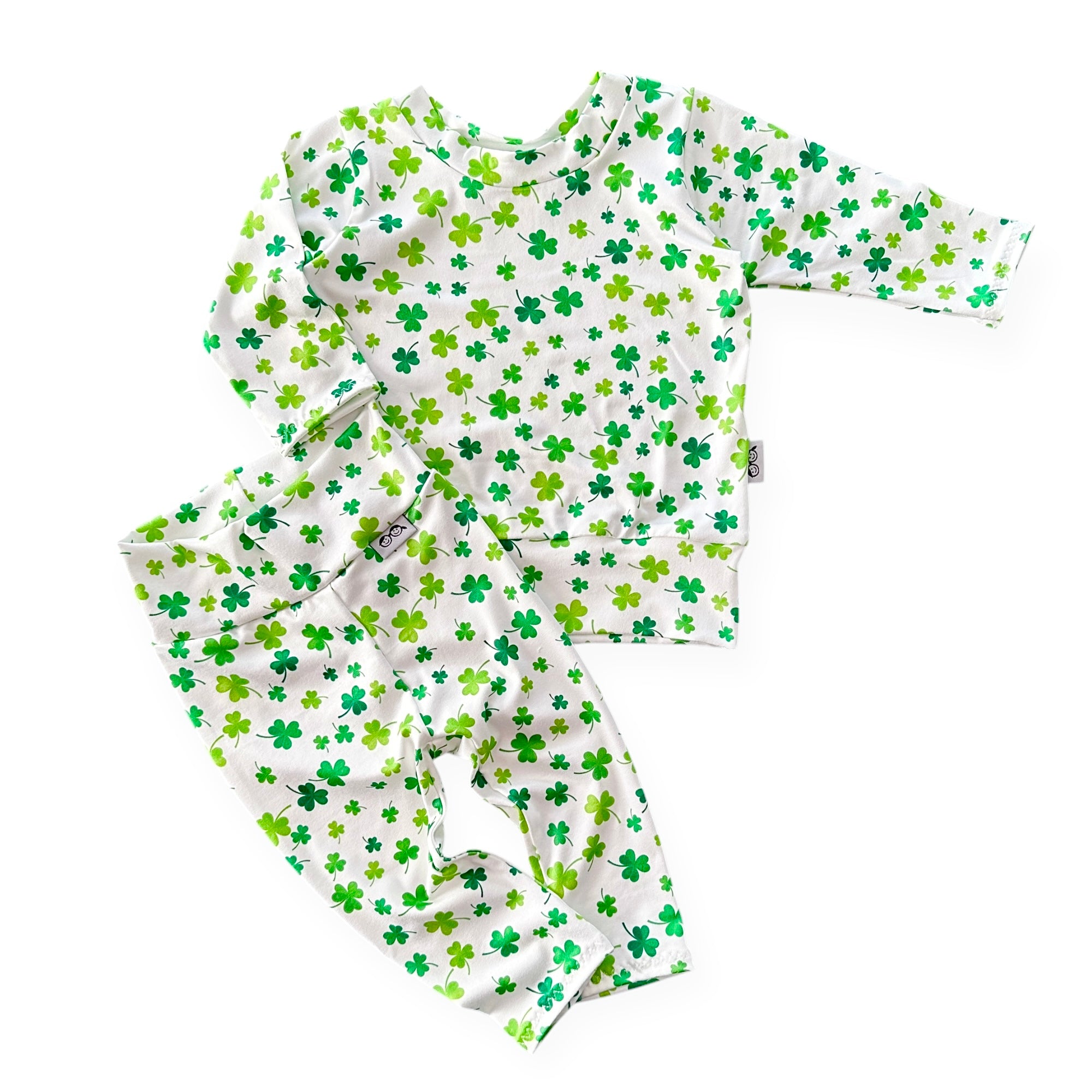 Handmade white shamrock lounge set for babies and toddlers, featuring a cozy top and matching leggings. Perfect for St. Patrick&
