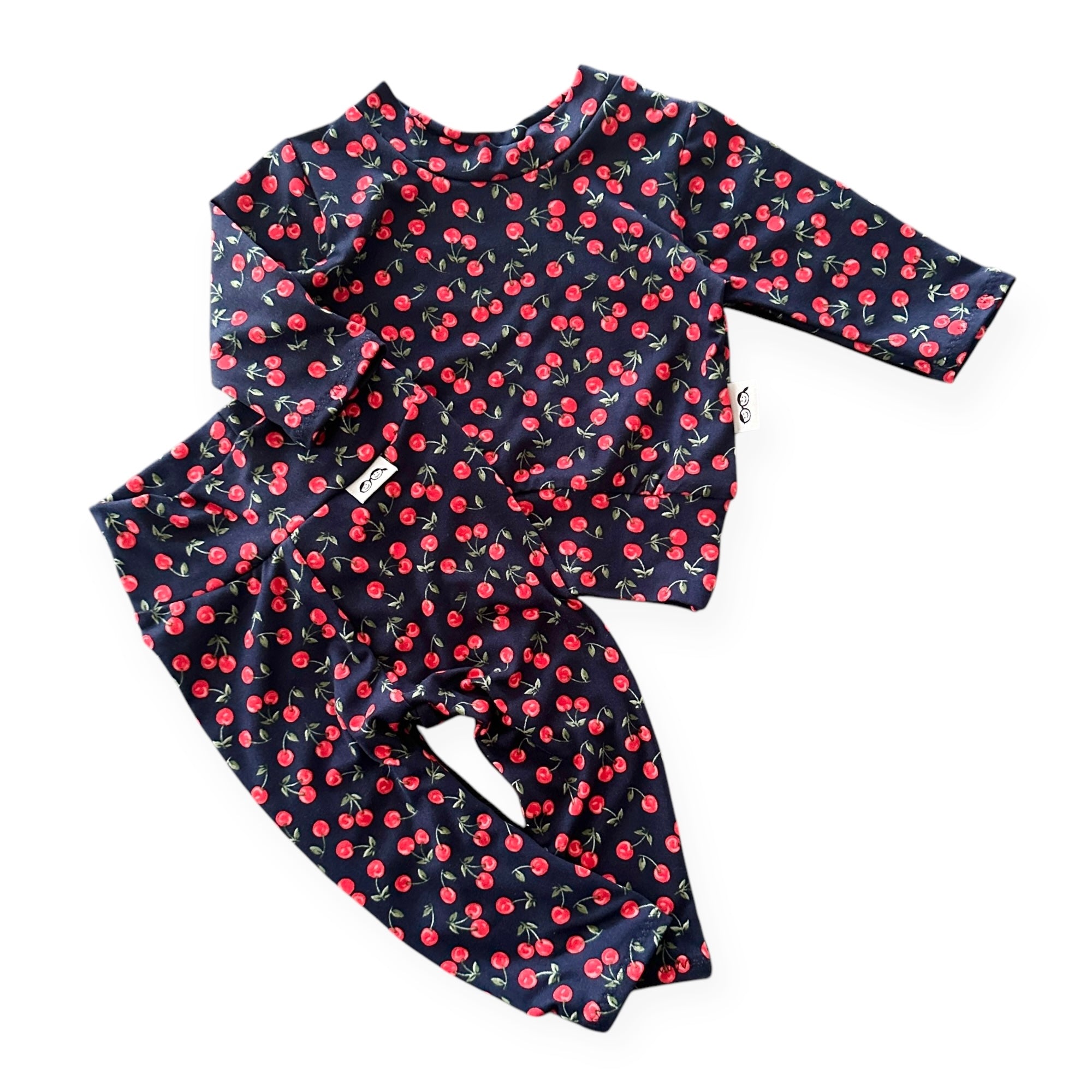 Midnight Cherries baby lounge set, featuring a long-sleeve pullover top and matching leggings in a navy blue cherry print. Soft, stretchy, and handmade for ultimate comfort.