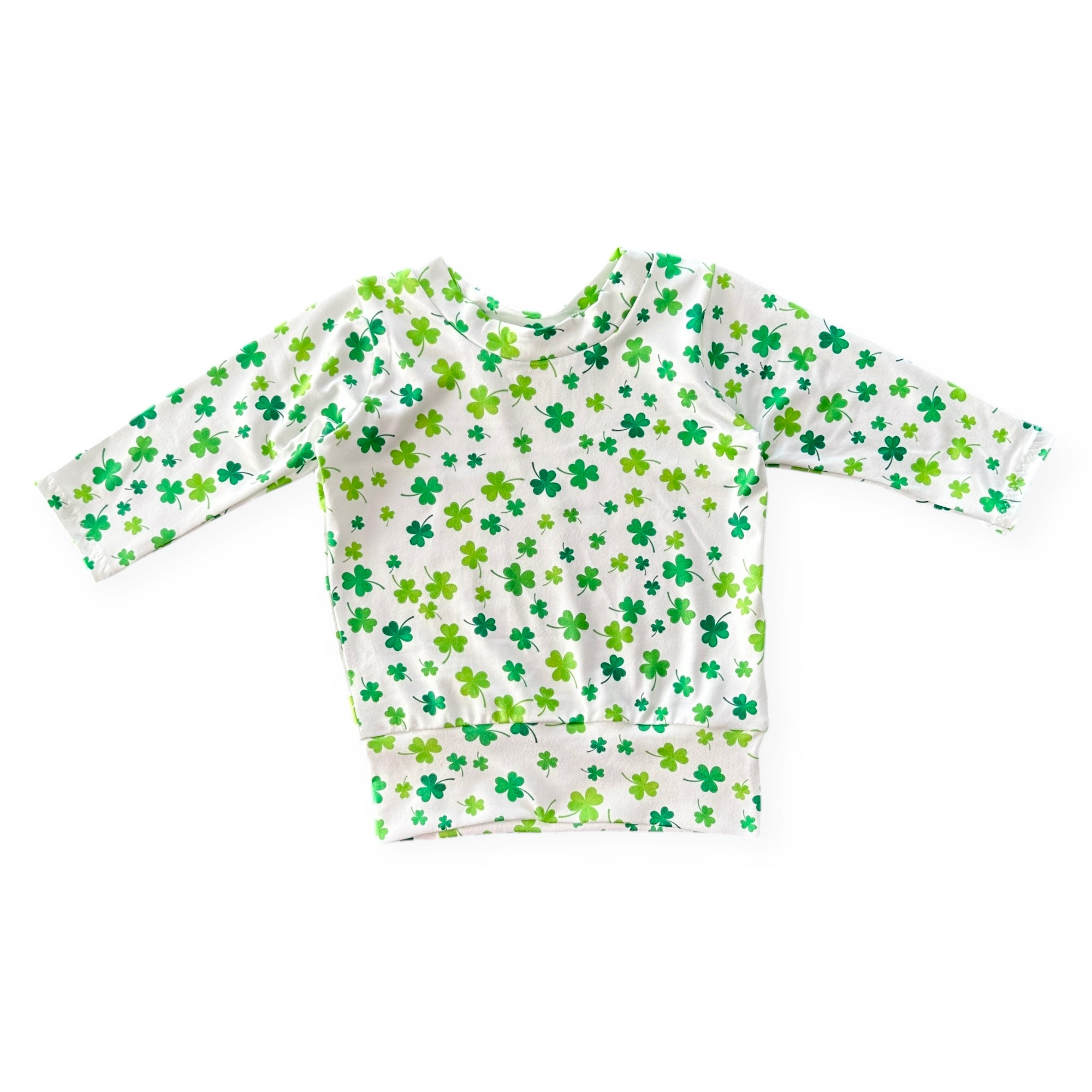 Handmade white lounge top with green shamrock print for babies and toddlers. Perfect for St. Patrick&
