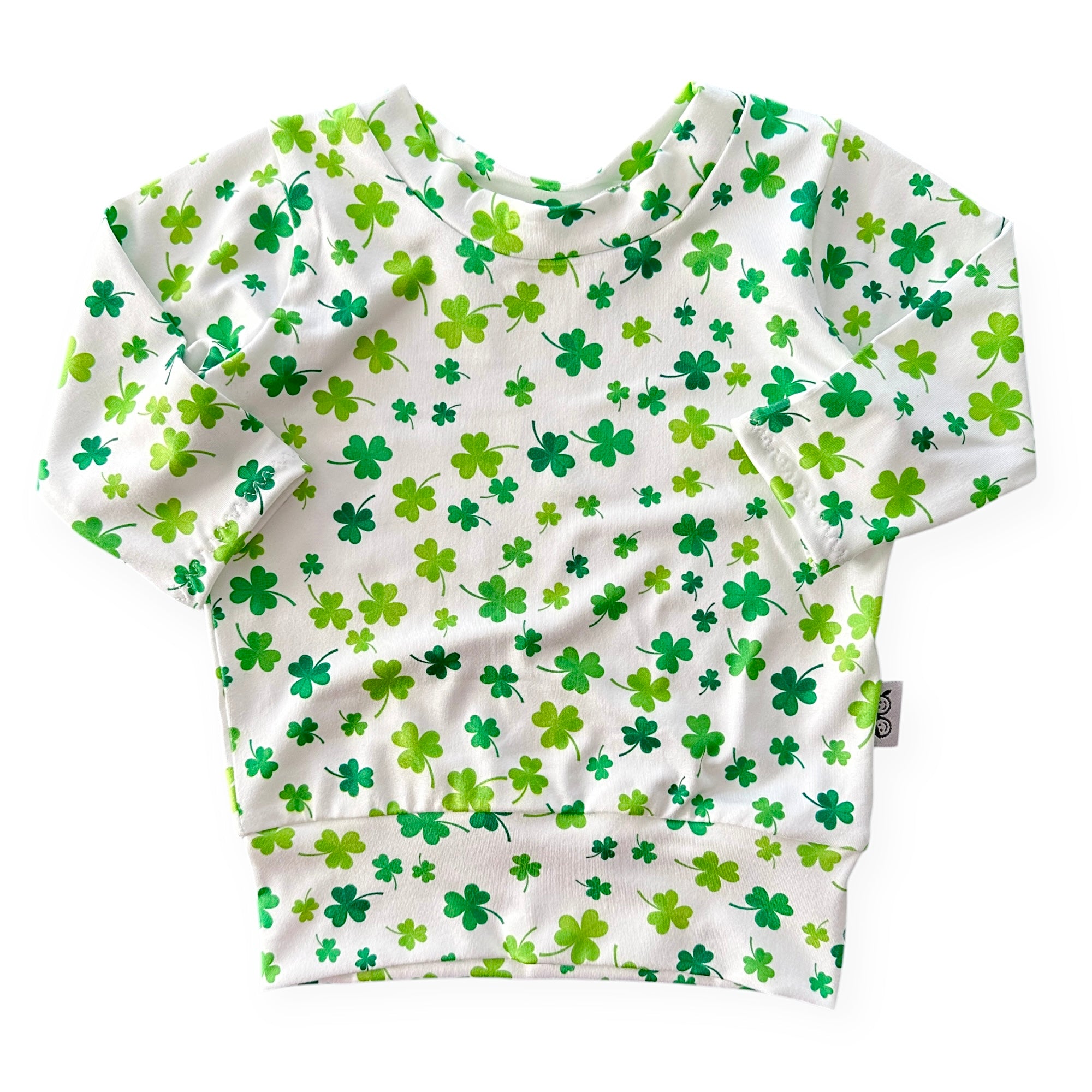 Handmade white lounge top with green shamrock print for babies and toddlers. Perfect for St. Patrick&