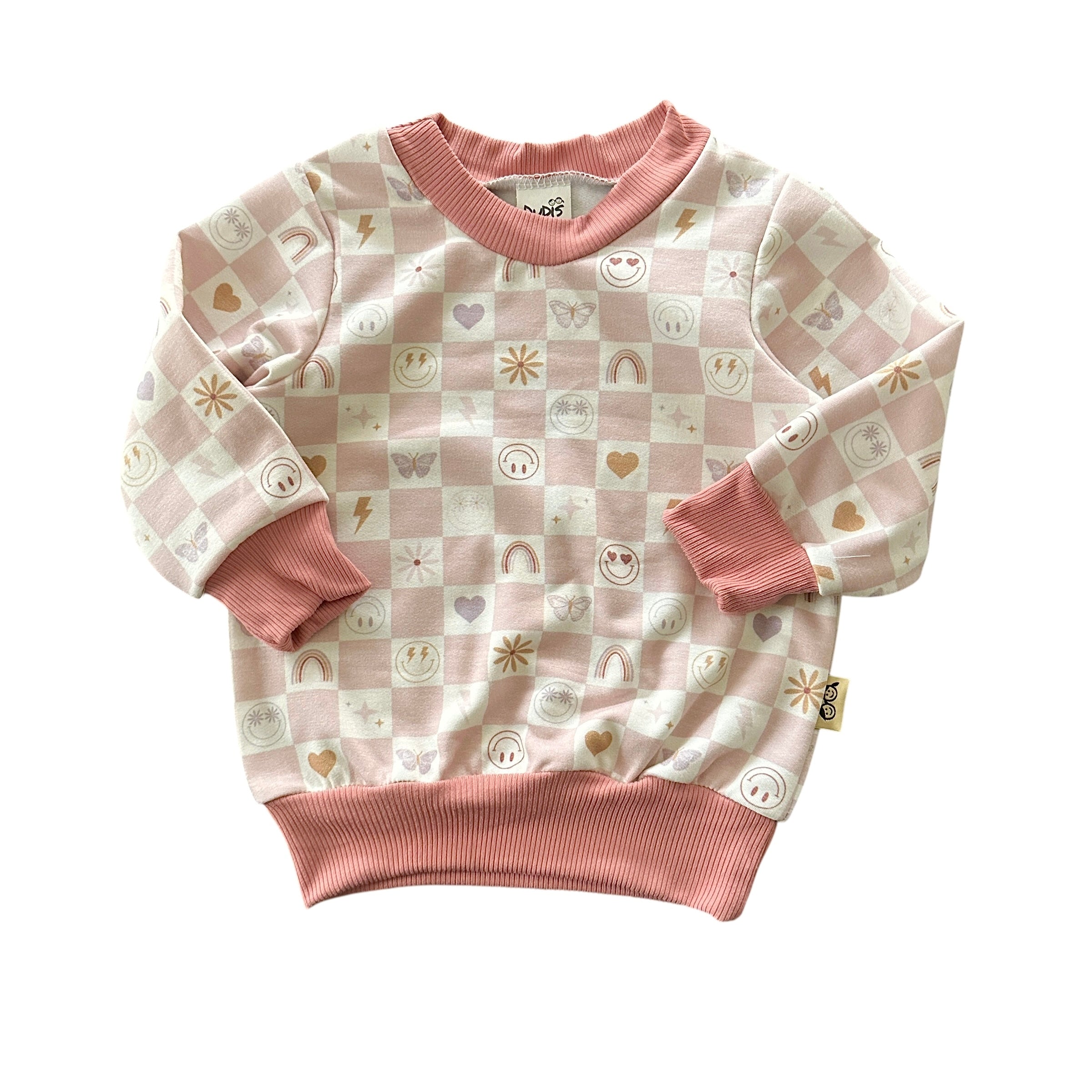 Front view of baby sweatshirt in blush checker smiley print with ribbed trim.