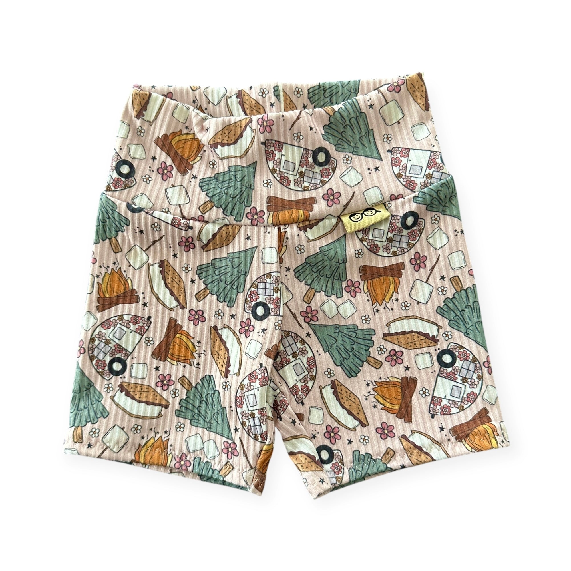 Baby biker shorts in cozy camping print with trees and s’mores.
