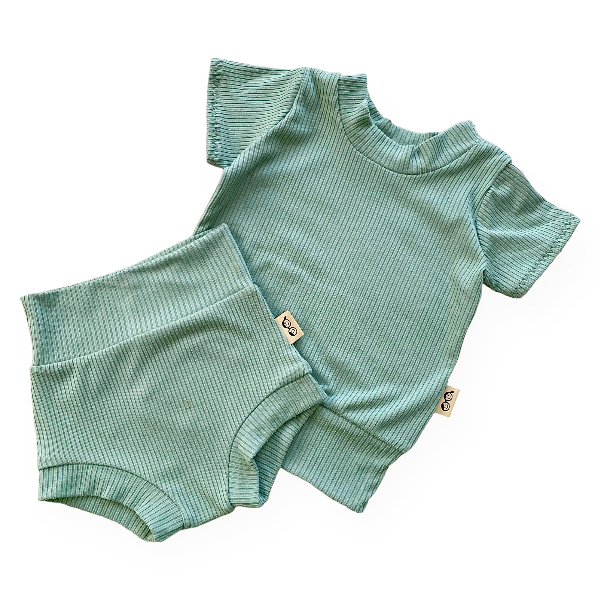 Sea Spray Ribbed Summer Lounge Set, featuring a short-sleeve ribbed top and matching bummies in a soft green hue for a stylish and comfy summer look.