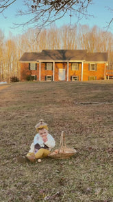 Little Girl in Mustard Ribbed Top Knot Headband, harvesting eggs