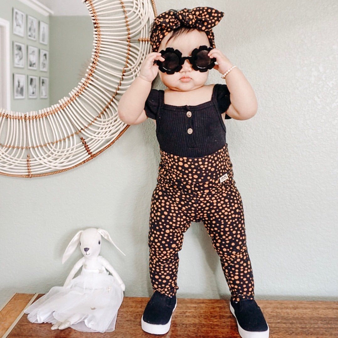 Baby standing wearing Black Abstract Micro Dot Leggings and/or Headbands