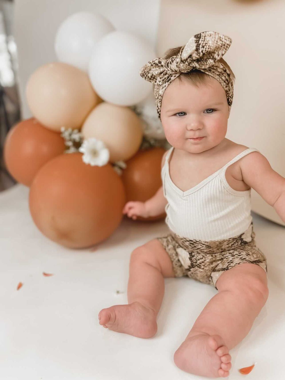 Baby Girl in Tan Snake Print Bummies