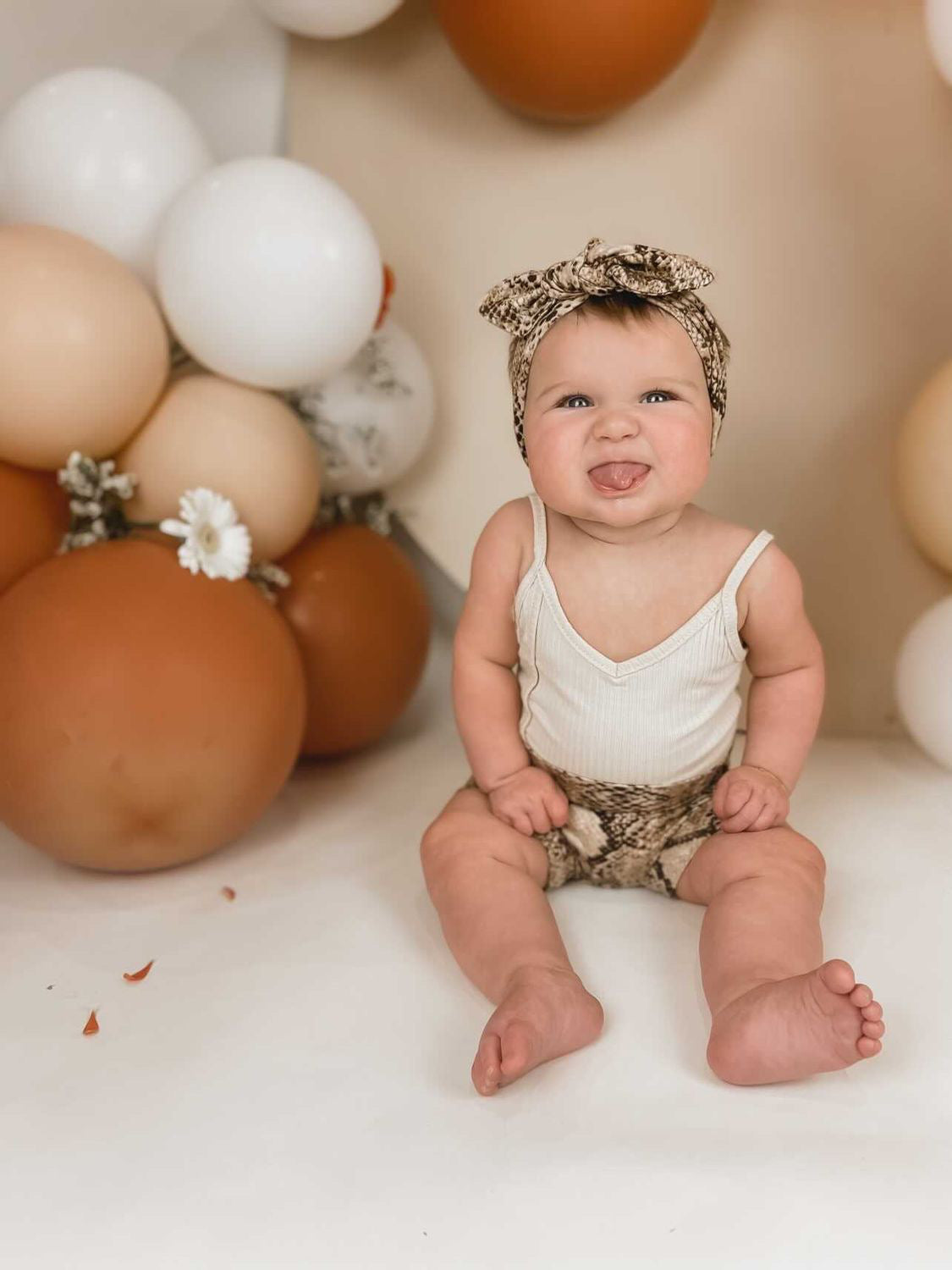Baby Girl in Tan Snake Print Bummies