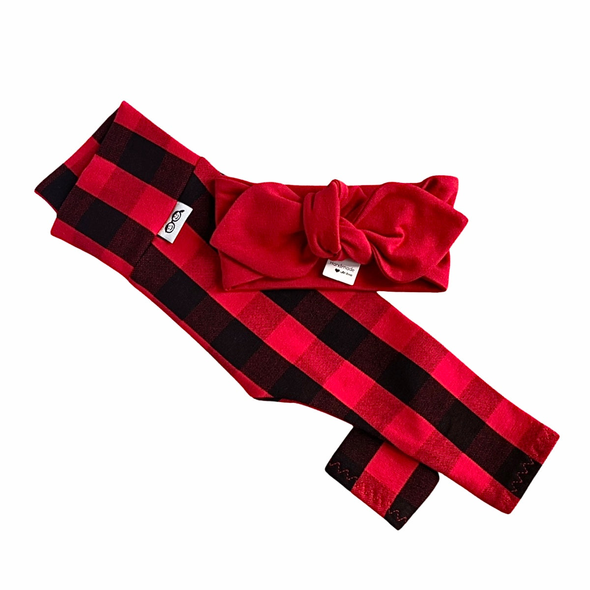 Handmade red buffalo plaid leggings paired with a matching solid red bow headband for babies and toddlers.