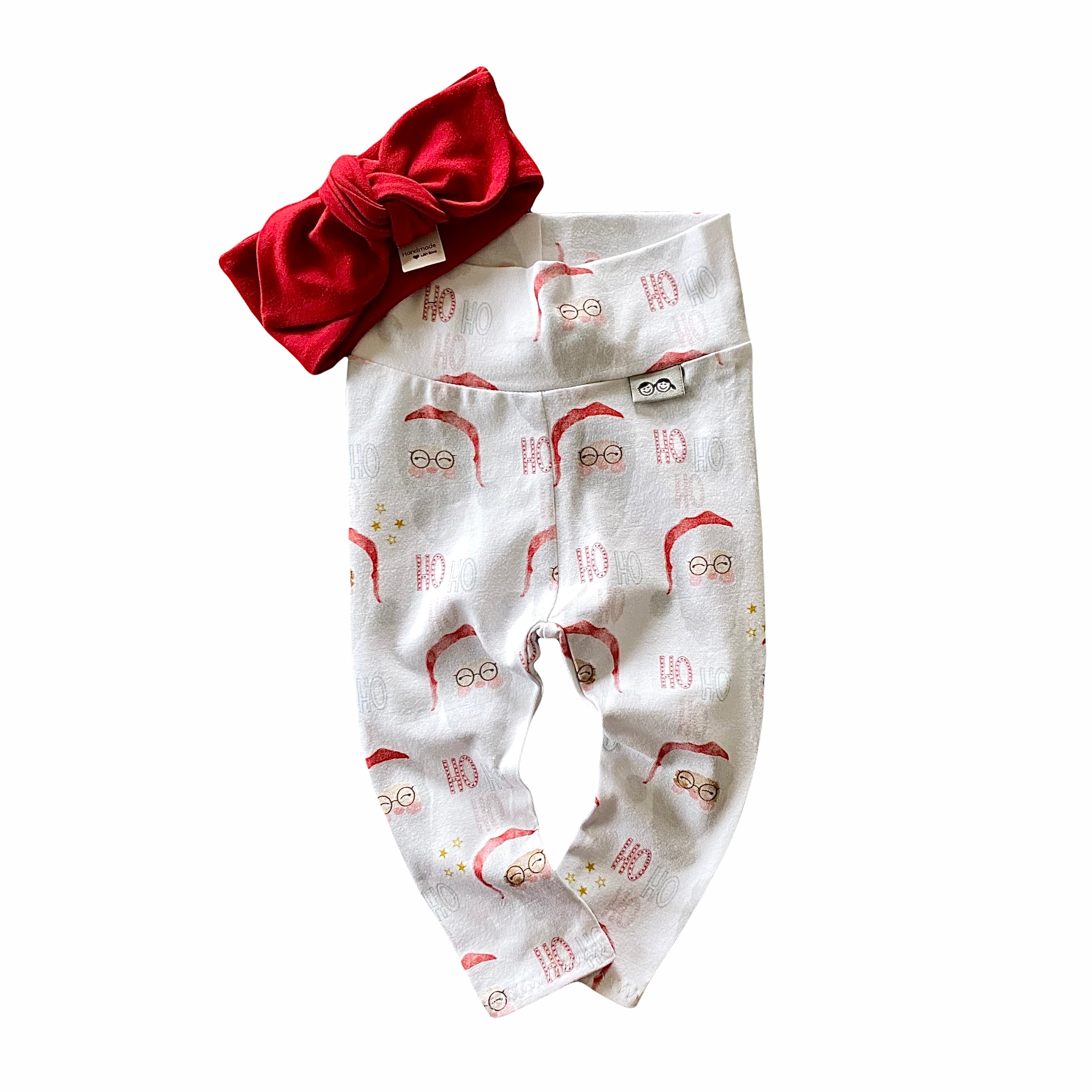 Vintage Santa leggings featuring a festive Santa Claus print, paired with a red bow headband. Handmade for babies and toddlers, perfect for Christmas photos and holiday celebrations.