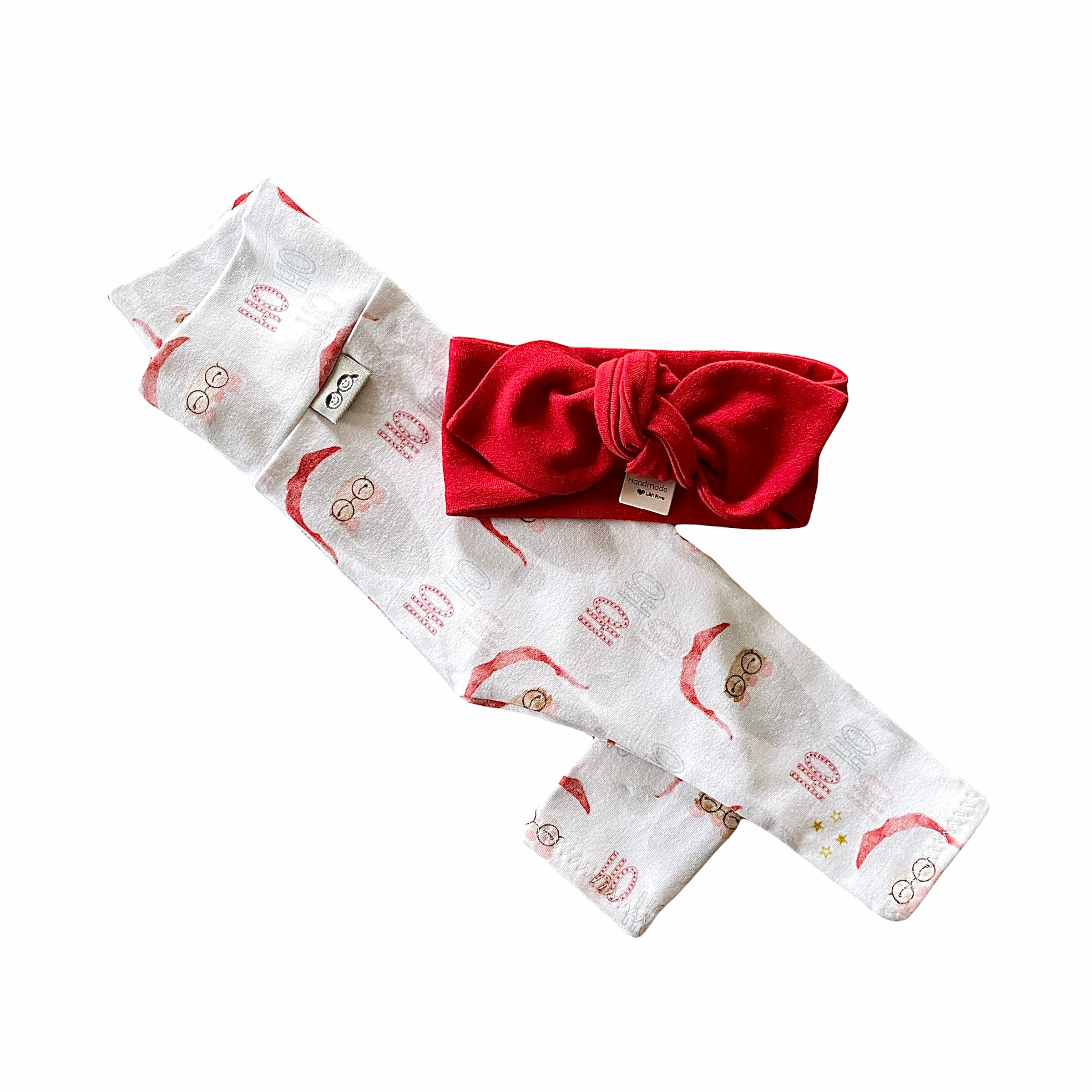 Vintage Santa leggings featuring a festive Santa Claus print, paired with a red bow headband. Handmade for babies and toddlers, perfect for Christmas photos and holiday celebrations.