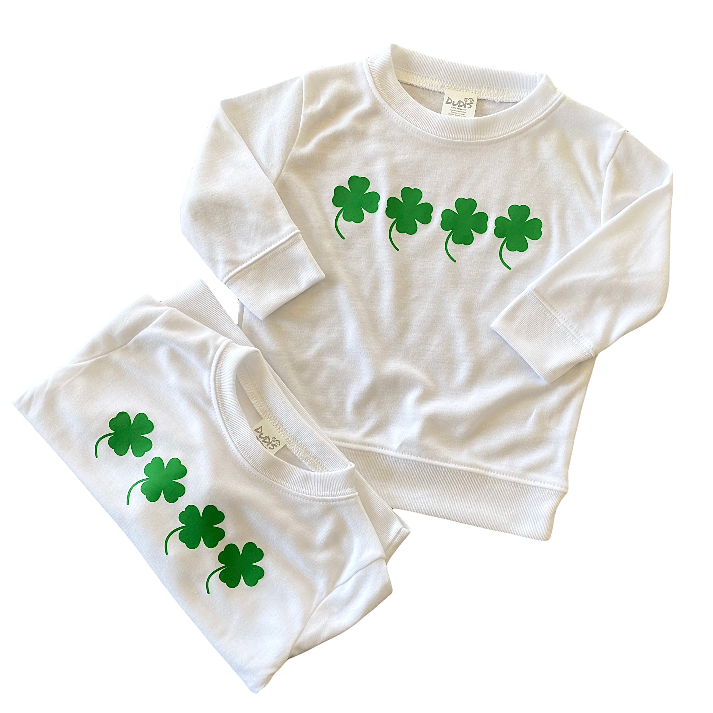 White baby and toddler shamrock sweatshirt featuring four green lucky clovers. This St. Patrick’s Day pullover is perfect for festive outfits, Irish celebrations, and casual wear. Soft, breathable fabric makes it a cozy and stylish choice for little ones. Sizes newborn to 4T available.