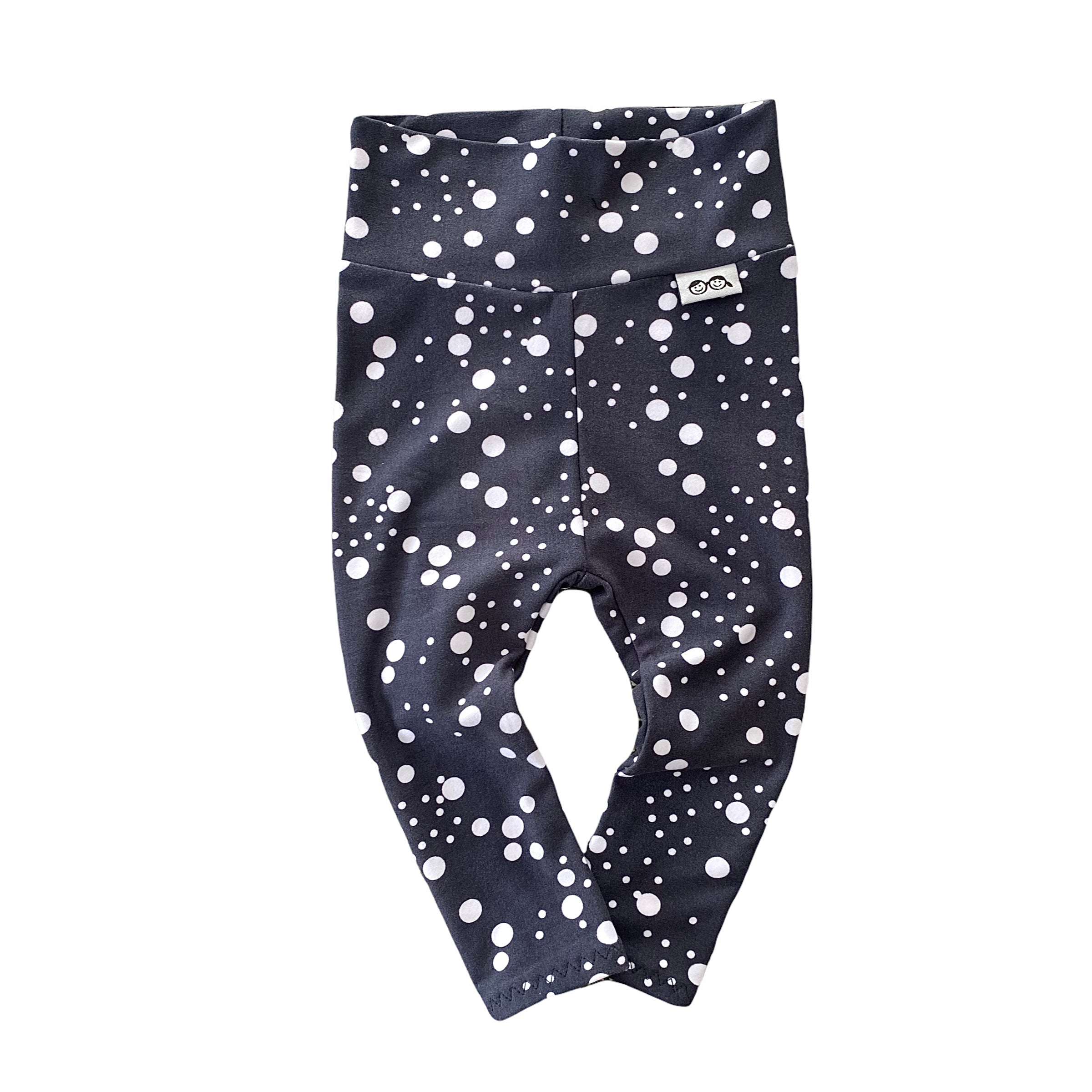 Handmade polka dot leggings for babies and toddlers, featuring a stylish black and white design. Soft, stretchy, and perfect for everyday wear, playtime, or special occasions. Designed for comfort and movement.