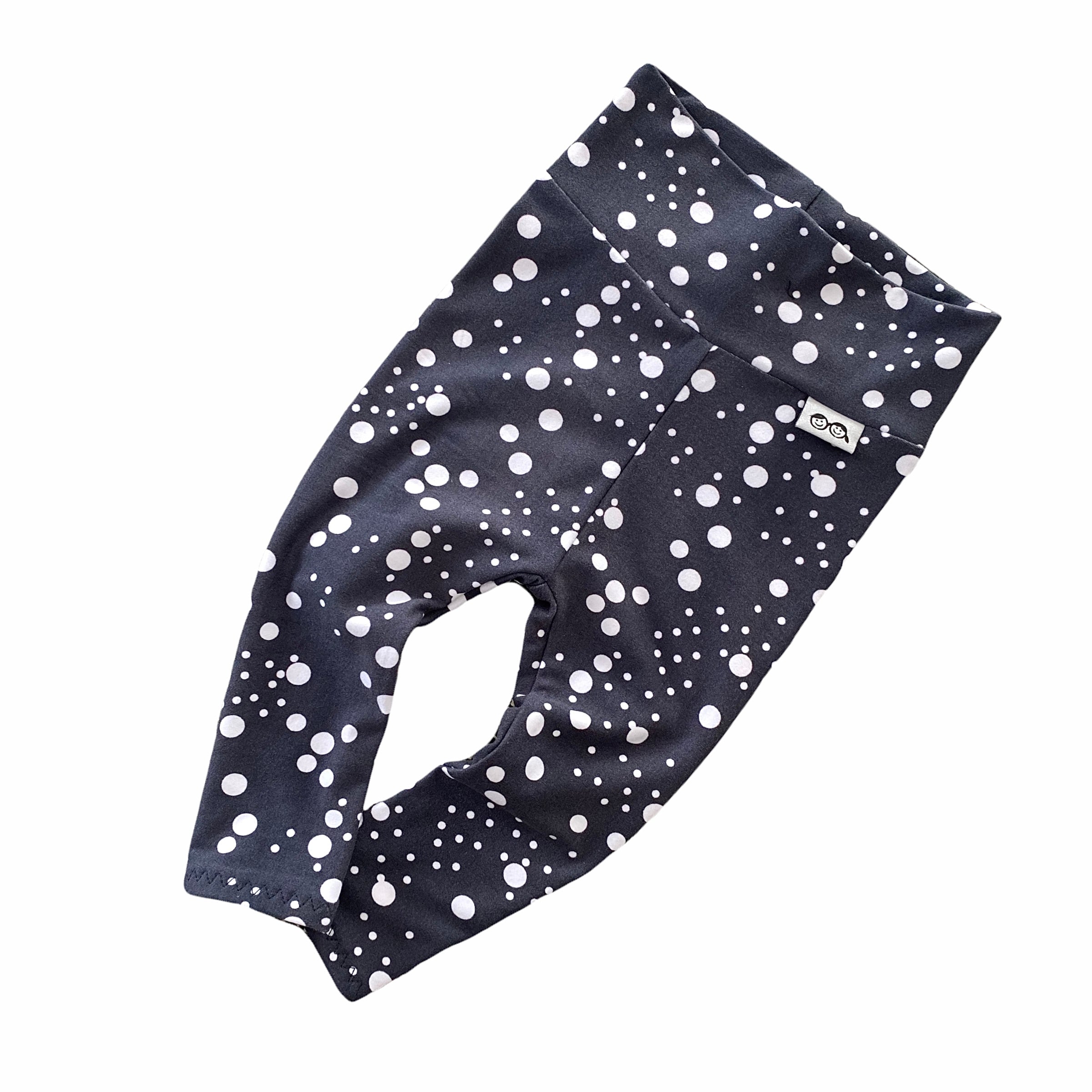 Handmade polka dot leggings for babies and toddlers, featuring a stylish black and white design. Soft, stretchy, and perfect for everyday wear, playtime, or special occasions. Designed for comfort and movement.