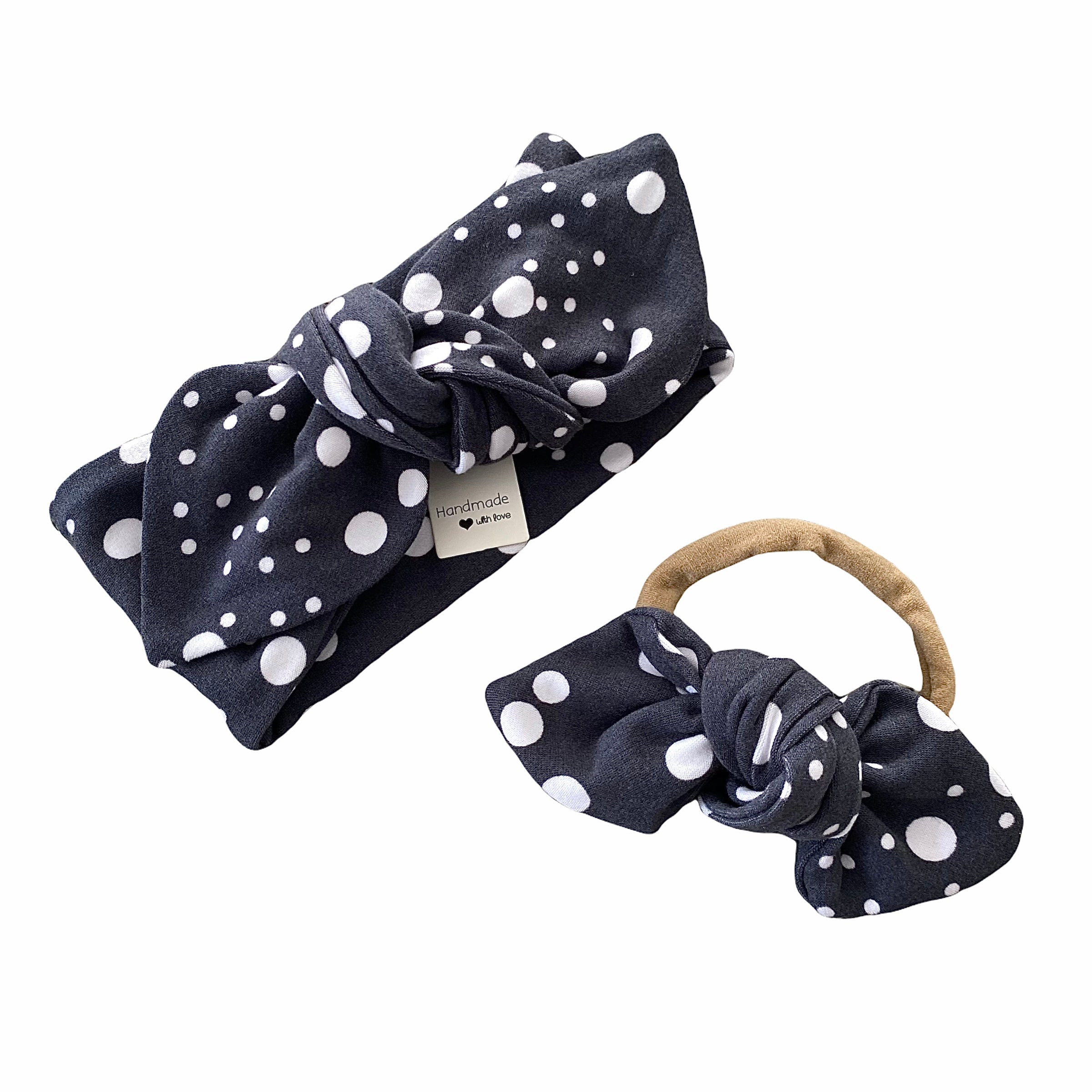 Handmade polka dot headbands for babies and toddlers, featuring a stylish black and white design. Includes a top knot headband and a bow on nylon, perfect for everyday wear or special occasions. Comfortable and adorable accessory for little ones.