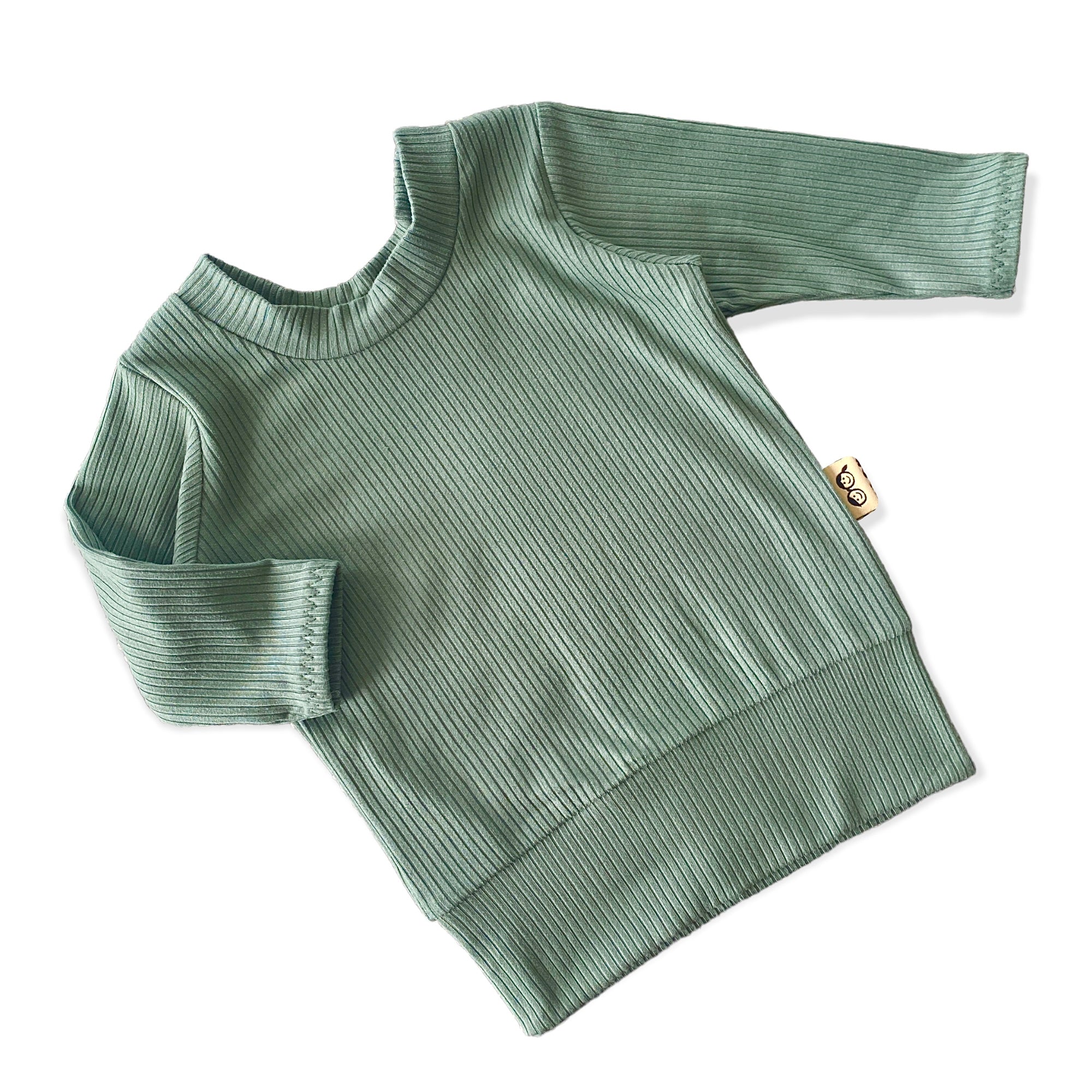 Close-up of the ribbed long-sleeve top from the Sea Spray Lounge Set in a soft green color, perfect for cozy days and easy pairing.