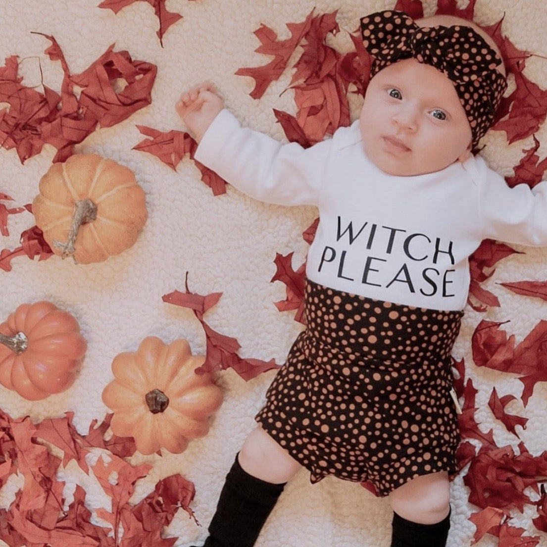 Baby wearing black abstract micro dots bummies and headbands