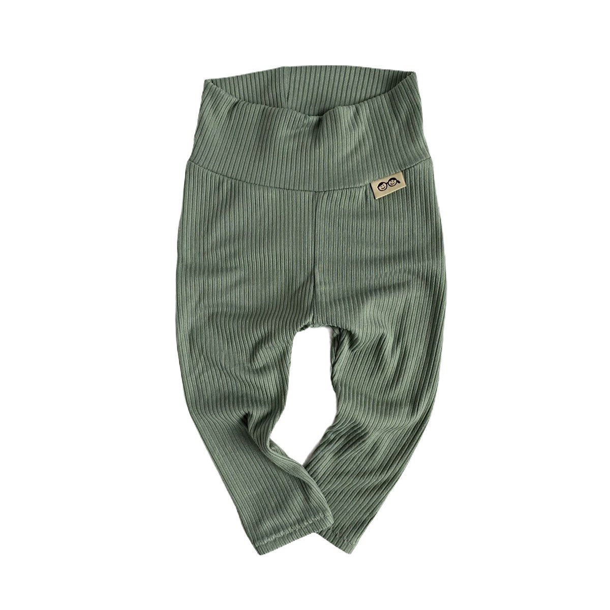 Flat-lay of soft ribbed green baby pants, featuring a wide waistband for comfort and flexibility.