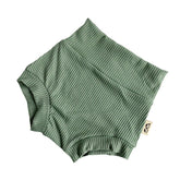 Flat-lay of ribbed green bummies for babies, designed with a high waistband for comfort and style.