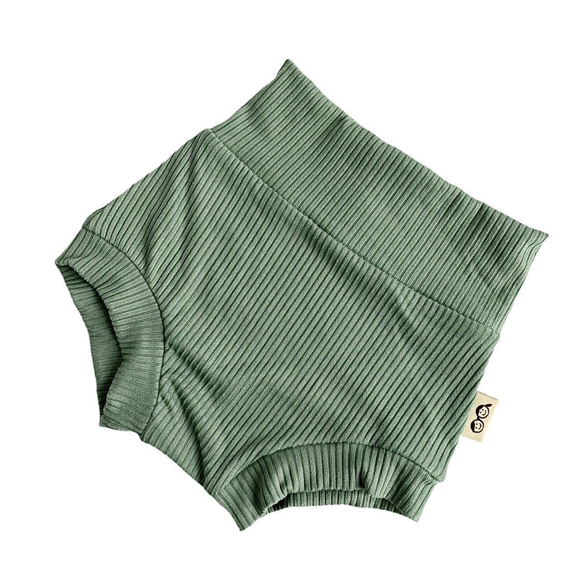 Flat-lay of ribbed green bummies for babies, designed with a high waistband for comfort and style.