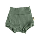 Flat-lay of ribbed green bummies for babies, designed with a high waistband for comfort and style.