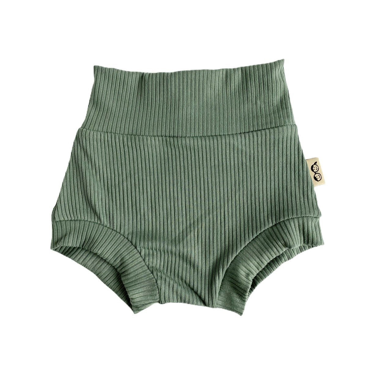 Flat-lay of ribbed green bummies for babies, designed with a high waistband for comfort and style.