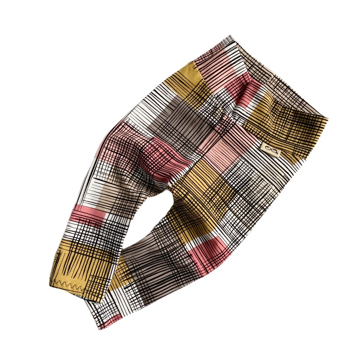 Flat-lay of Retro Plaid Leggings featuring a colorful and vibrant plaid pattern with a wide waistband for comfort.