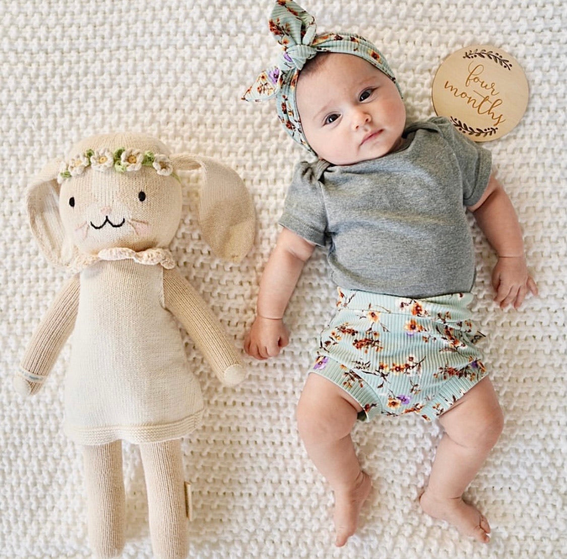 Baby Girl Wearing Dried Floral on Sage Ribbed Bummies