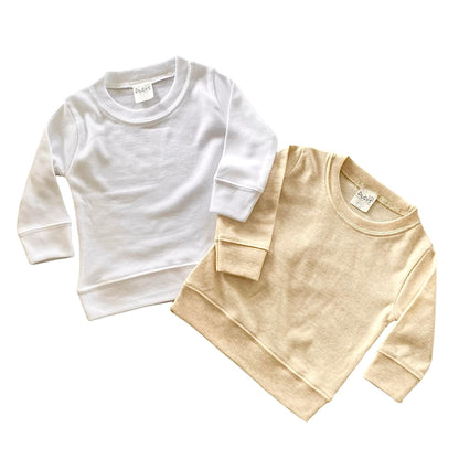 baby pullovers in white and cream