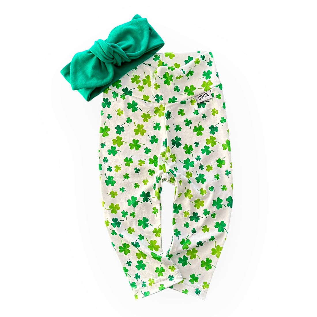 Festive green shamrock print leggings paired with a matching knotted headband, perfect for St. Patrick&