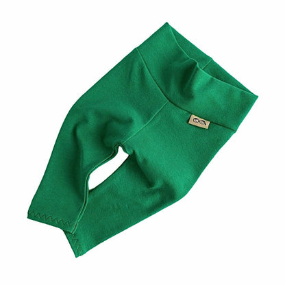 Handmade green baby leggings with a fold-over waistband, displayed on a white background. Soft, stretchy, and perfect for newborns, infants, and toddlers. A stylish and comfortable option for St. Patrick’s Day outfits, festive wear, or everyday layering. Available in sizes preemie to 4T