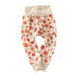 Neutral cream harem pants with coral and mustard leopard spots, belly-friendly waistband, unisex handmade baby pants.
