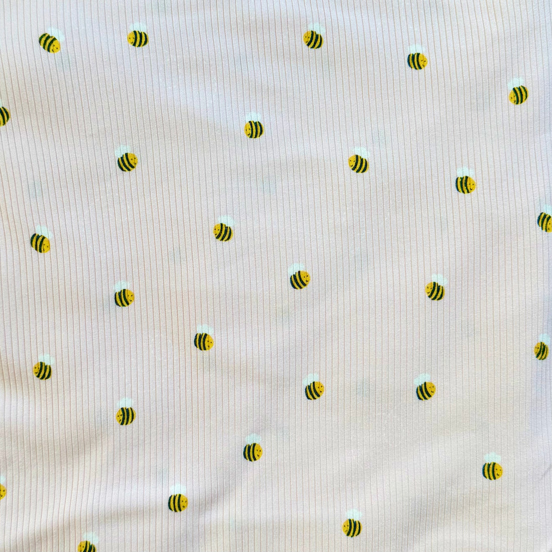 Pattern of small bees on a textured beige background