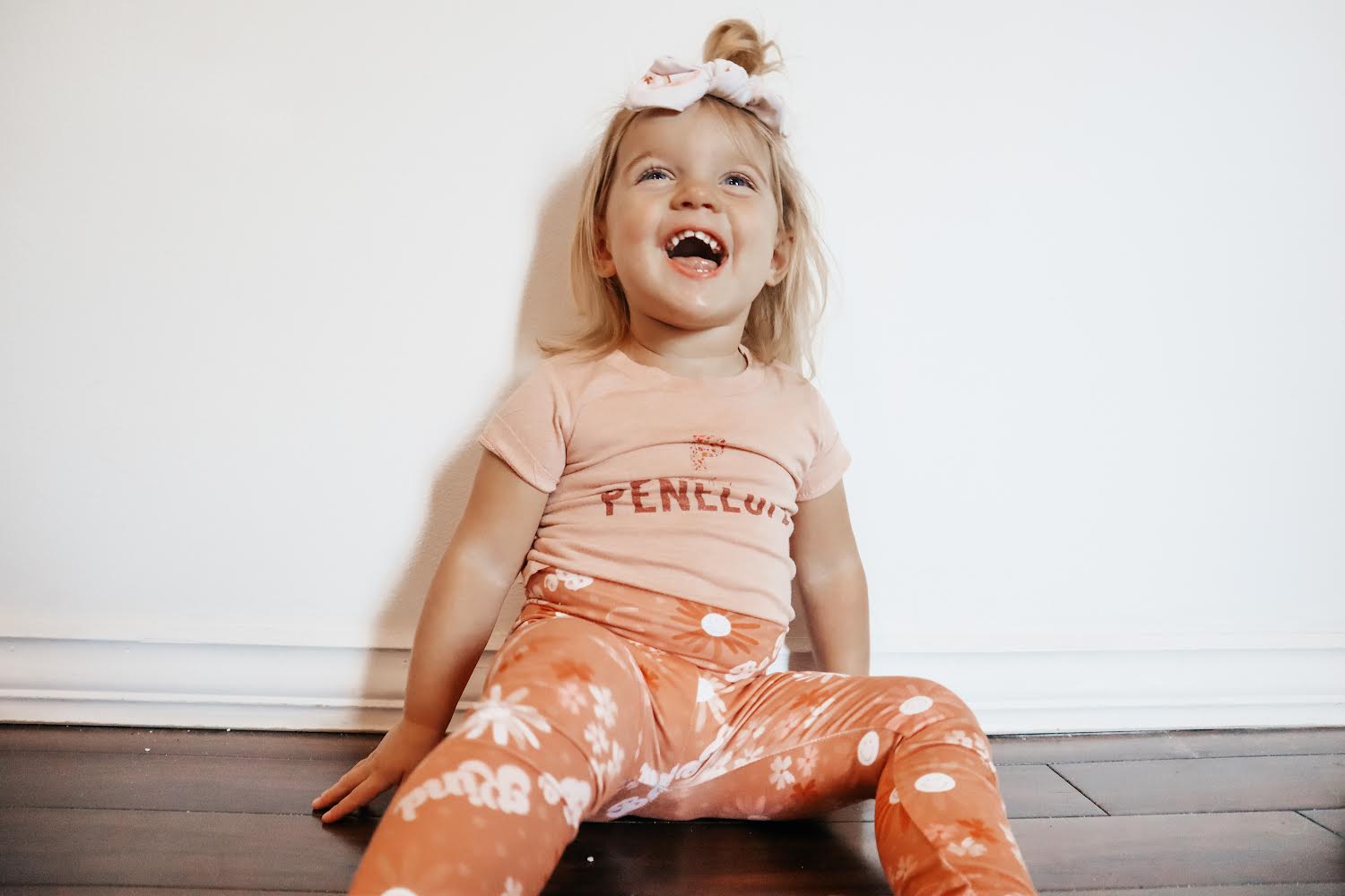 Child wearing a pink shirt with &