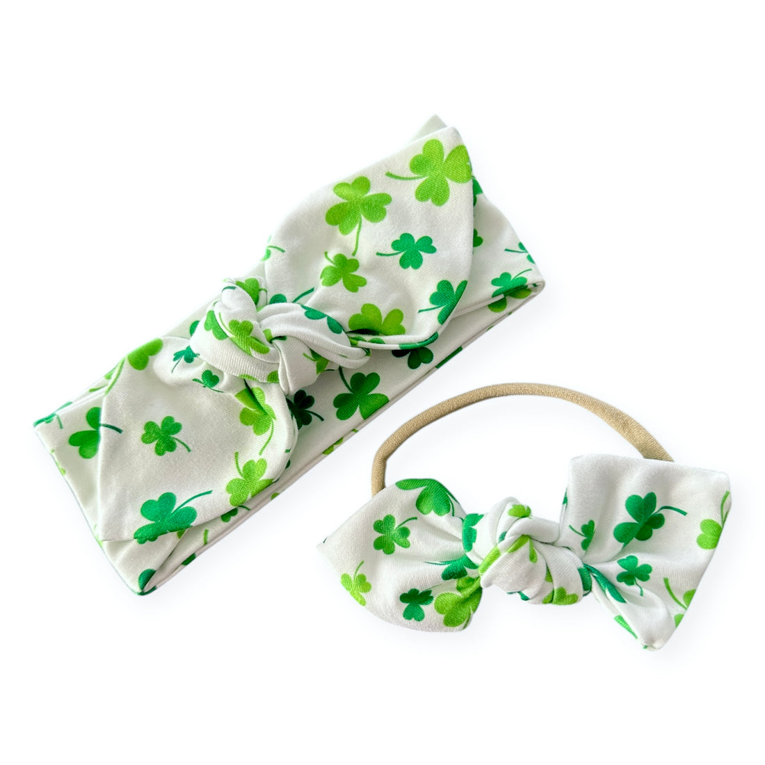 Handmade white shamrock headbands for babies and toddlers, featuring a festive St. Patrick&