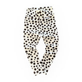 Baby leggings in white with bold black polka dots, featuring a soft high waistband. Comfortable and stylish handmade baby pants for everyday wear.