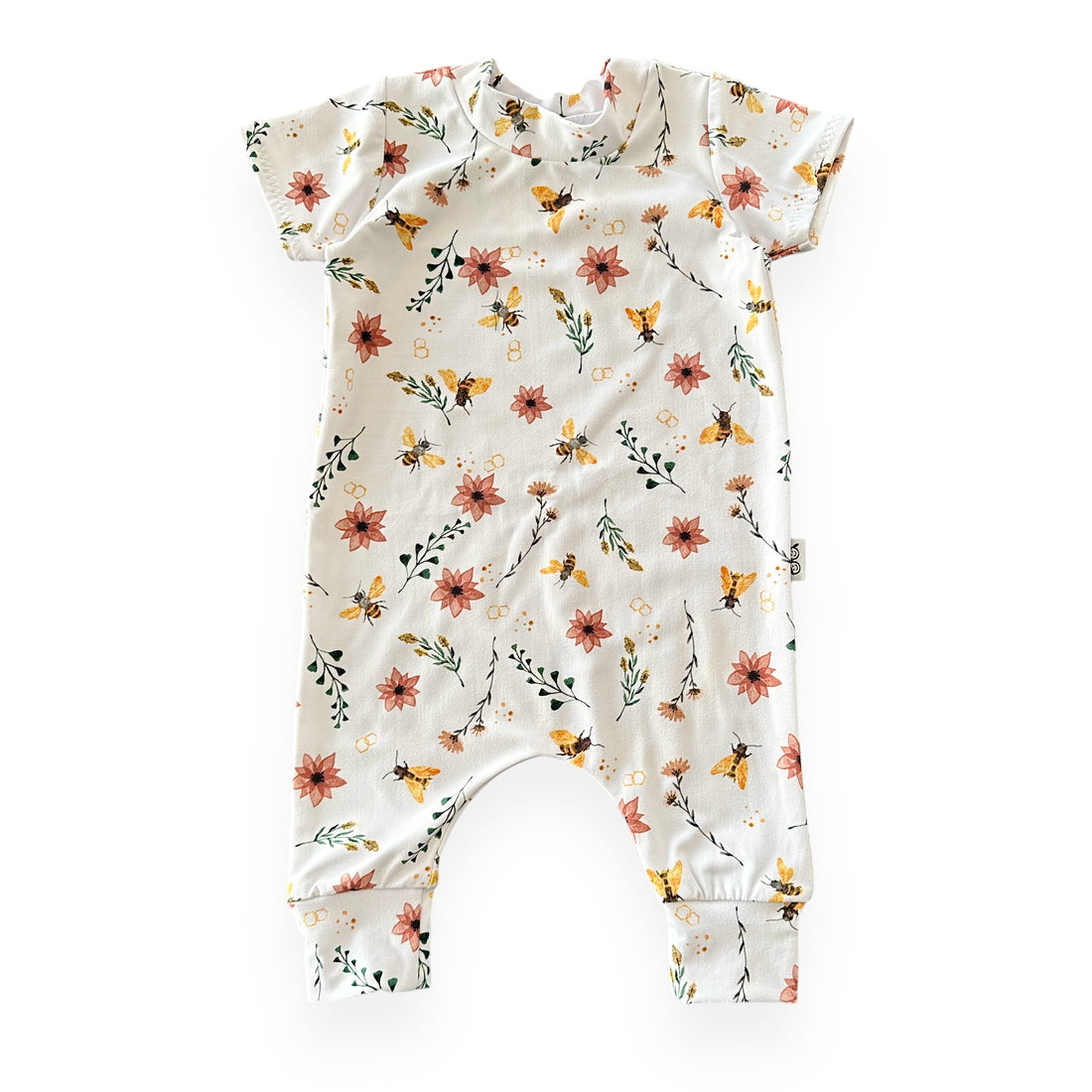 Cream baby romper with yellow bees, coral flowers, green leaves, and honeycomb accents – soft stretch fabric, short sleeves, flat lay.