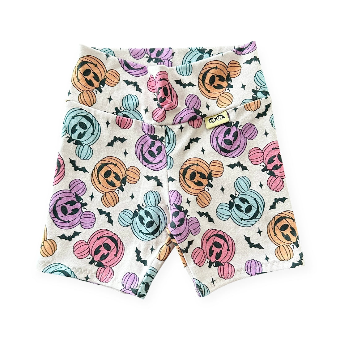 Shorts with Halloween-themed pumpkins and ghosts pattern on a white background