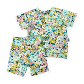 Floral patterned shirt and shorts set on a white background