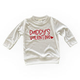 A soft, white pullover with the phrase "Daddy&