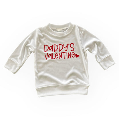 A soft, white pullover with the phrase &quot;Daddy&