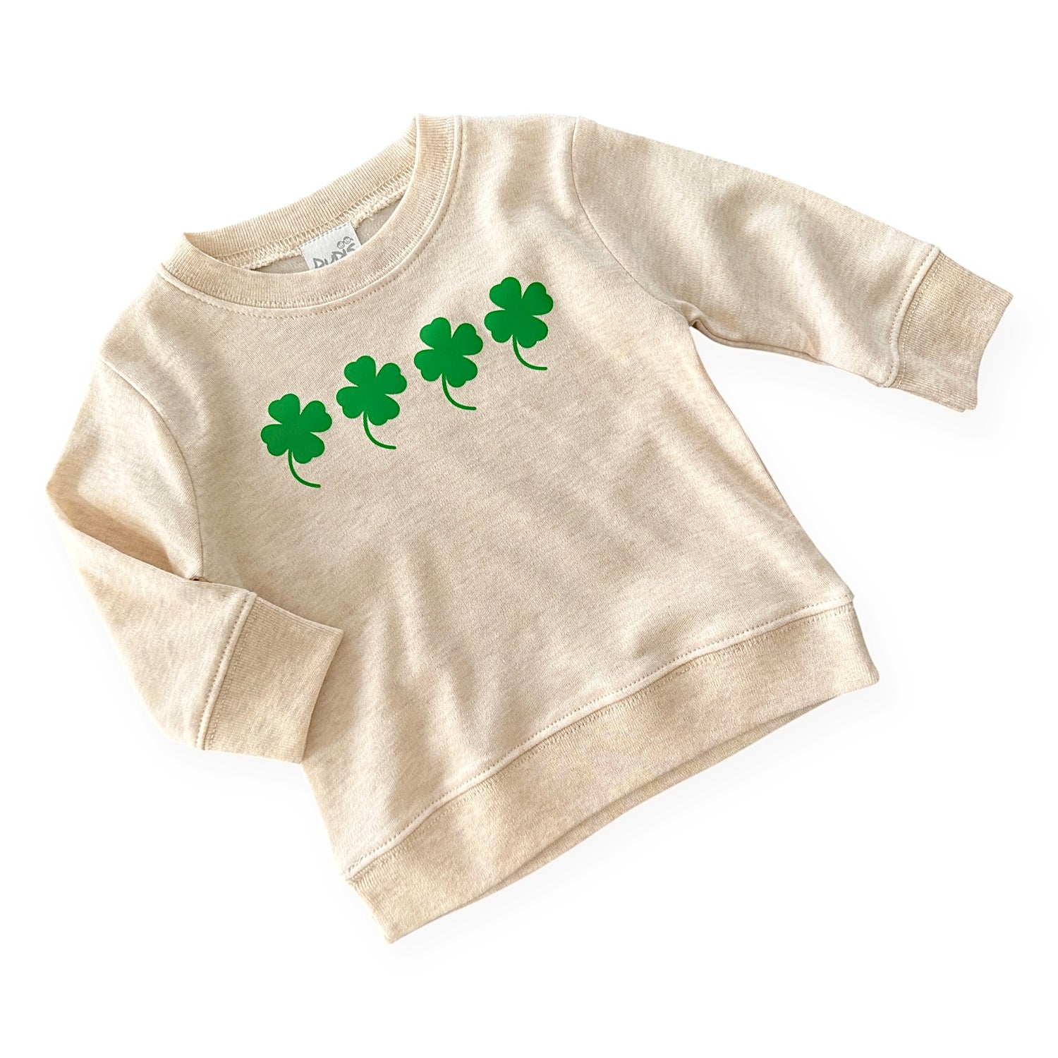 Neutral cream baby and toddler pullover with four green shamrocks printed across the chest. A cozy and stylish St. Patrick’s Day sweatshirt, perfect for boys and girls. Soft, comfortable, and great for festive celebrations or everyday wear. Available in sizes newborn to 4T.