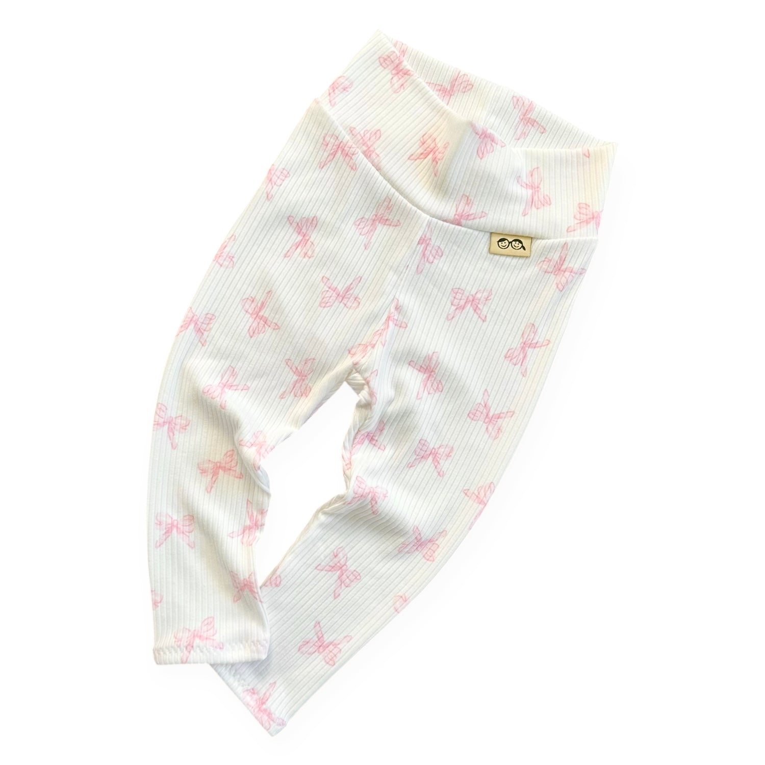 Baby leggings with pink bow pattern on a white background