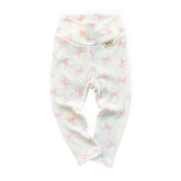 White baby leggings with pink bow pattern on a white background