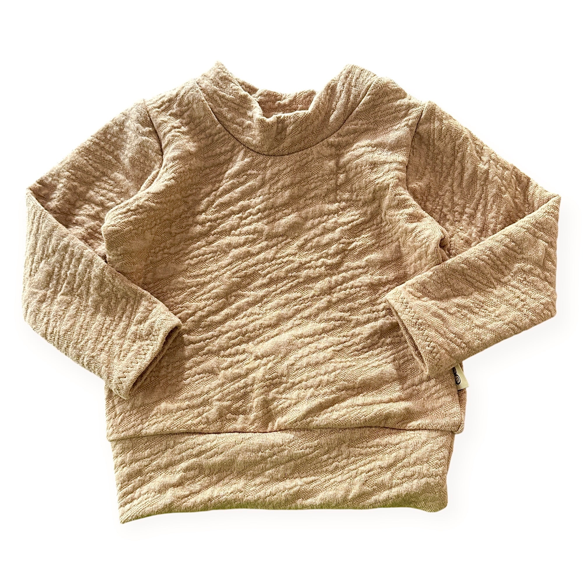 Beige textured sweater on a white background